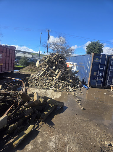 A pile of rubble sitting on top of a dirt road