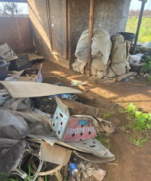 A pile of junk sitting next to a building