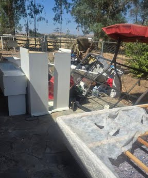 A couple of white boxes sitting on top of a dirt field