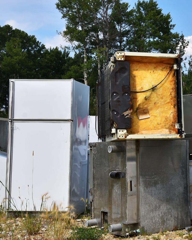Old washer, dryer, stove and refrigerator set out for appliance removal in Fresno, CA