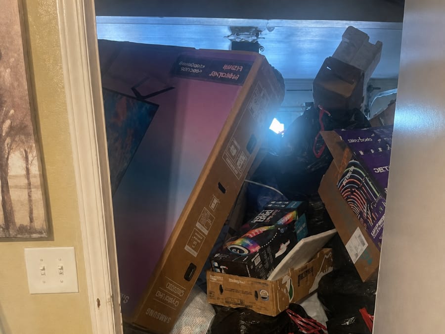 Fresno garage packed floor to ceiling with boxes and bagged junk ahead of a cleanout