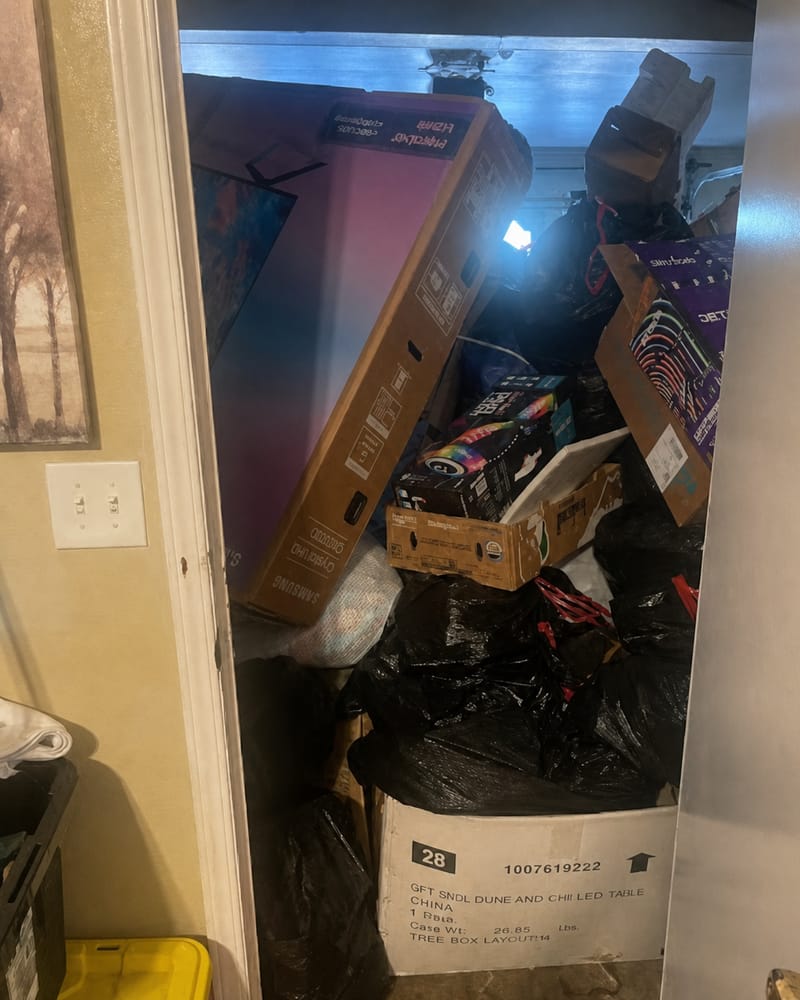Fresno garage stacked with boxes, bags and stored clutter before a cleanout