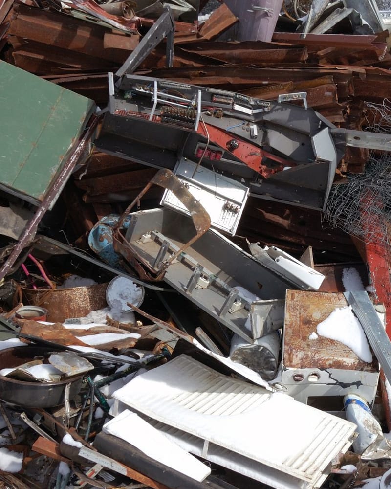 Mixed commercial waste load of scrap metal, timber and old appliances awaiting sorting