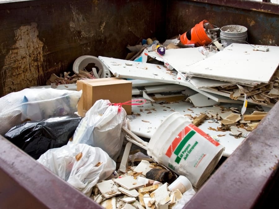 Drywall offcuts, buckets and renovation debris covering the floor of a Fresno remodel