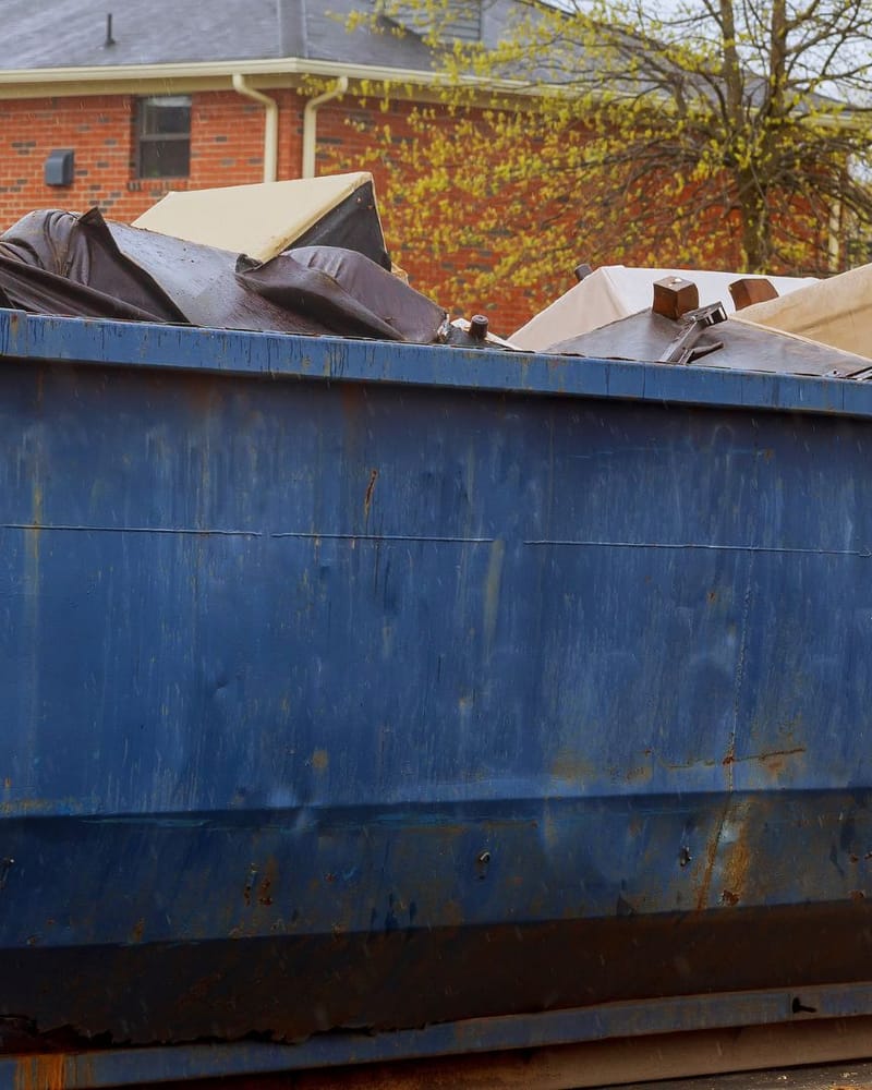 Loaded roll-off dumpster outside a Fresno commercial property during a business clear-out