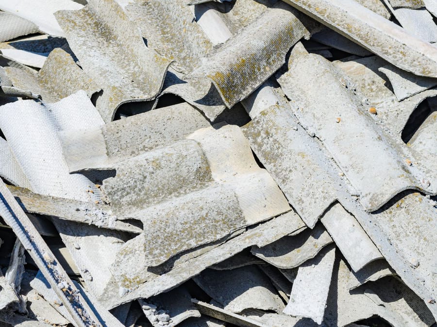 Stacked corrugated roofing sheets removed during a commercial tear-off in the Central Valley