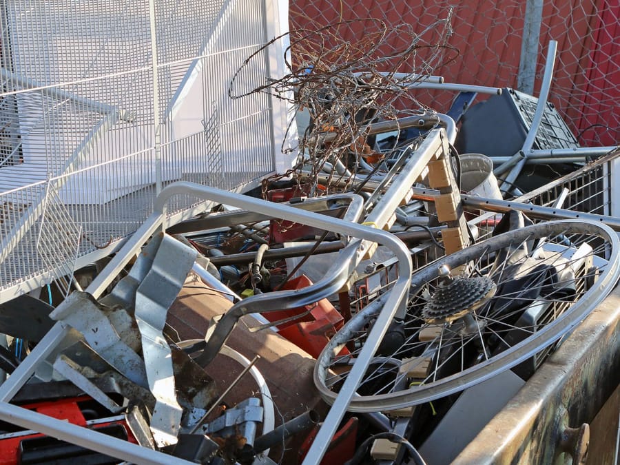 Separated scrap metal and electronics staged for recycling after a Fresno collection