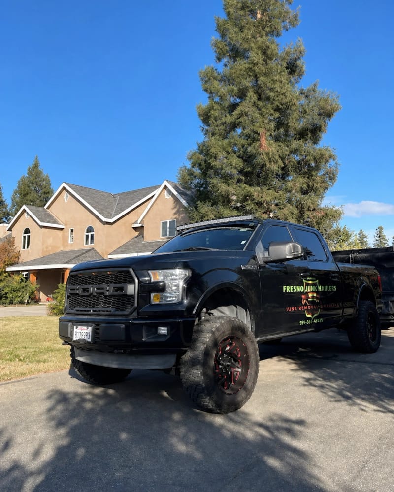 Jeremy Bowers' branded Fresno Junk Haulers truck parked at a customer's home in Fresno, CA